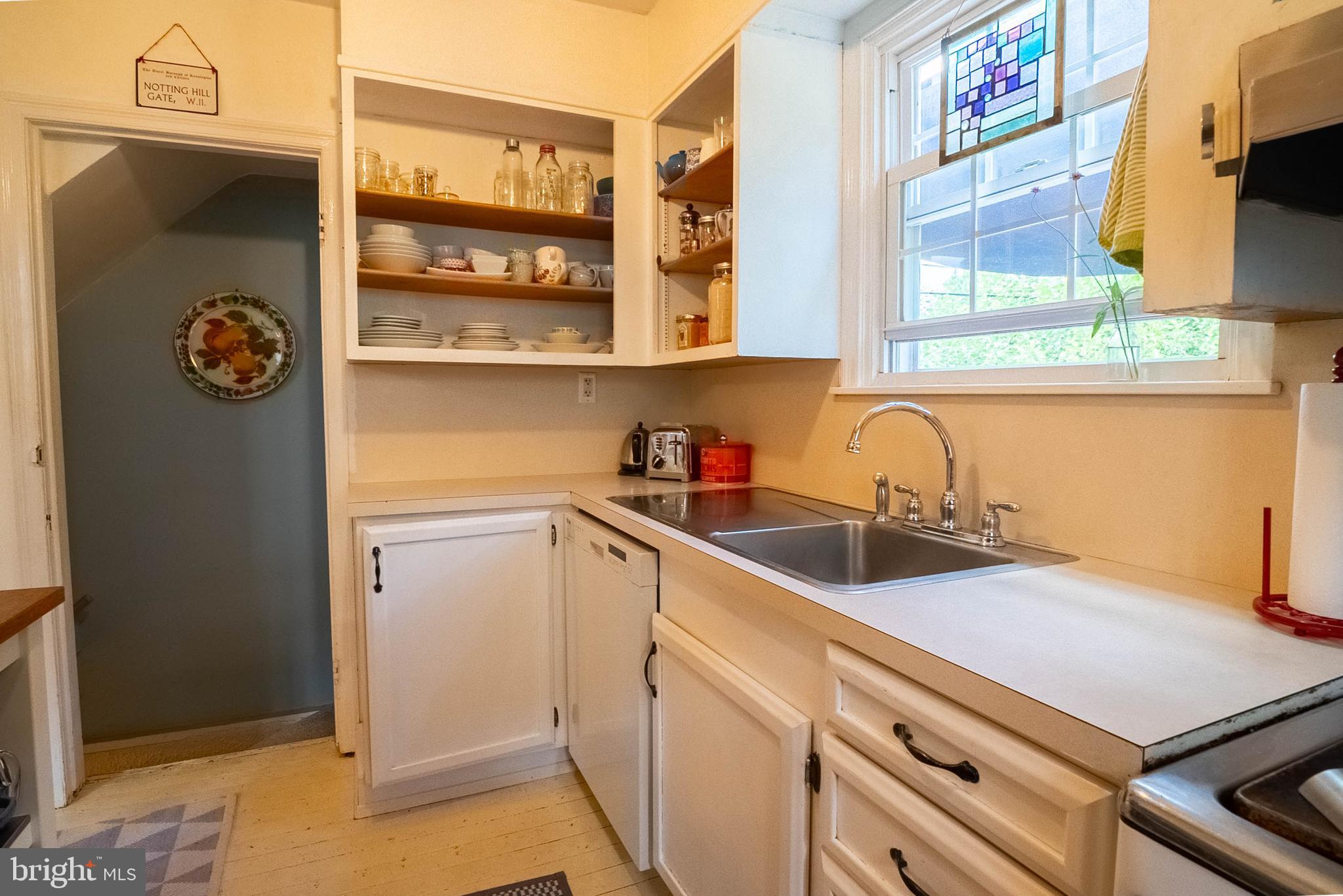 6400 Crestwood Road Baltimore, MD 21239 - Photo 19 of 39 a kitchen with a sink and a refrigerator
