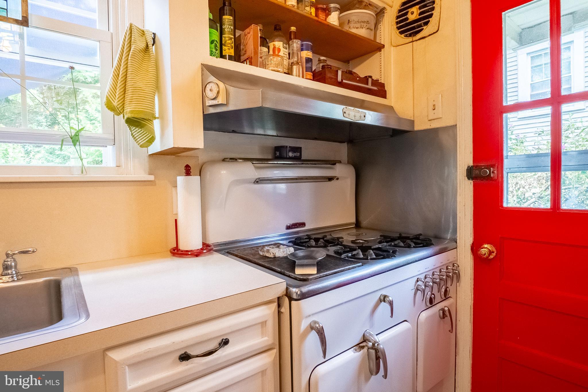 6400 Crestwood Road Baltimore, MD 21239 - Photo 20 of 39 a kitchen with a stove a sink and a microwave