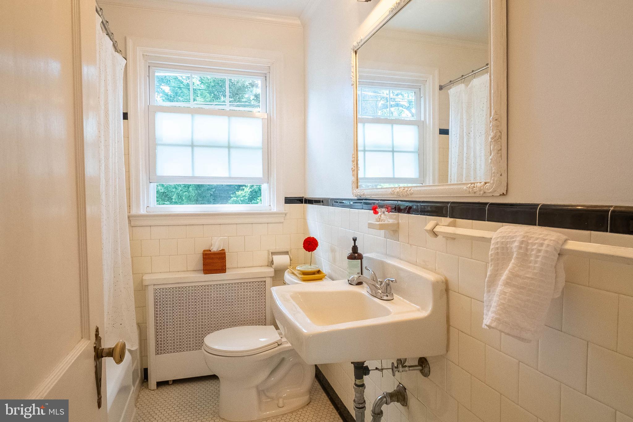 6400 Crestwood Road Baltimore, MD 21239 - Photo 21 of 39 a bathroom with a sink a toilet and a window