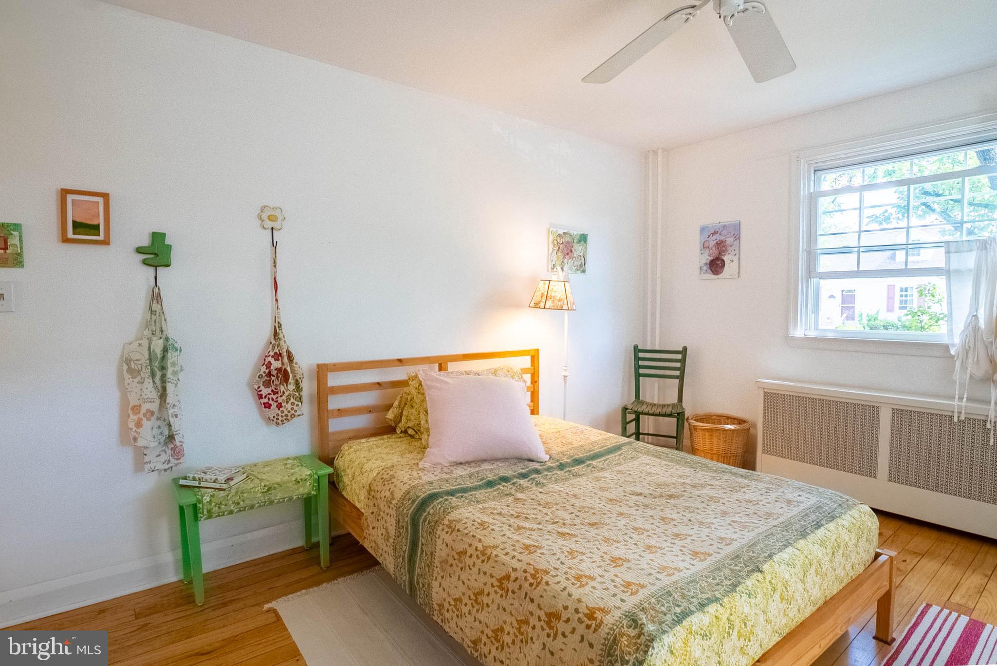 6400 Crestwood Road Baltimore, MD 21239 - Photo 22 of 39 a bedroom with a bed and wooden floor