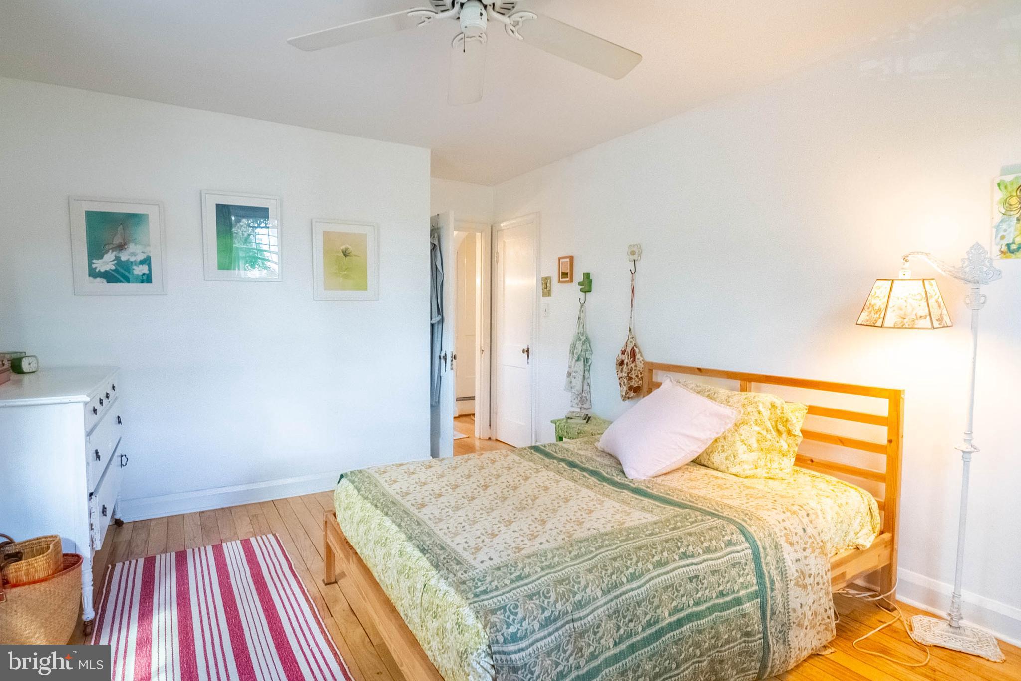 6400 Crestwood Road Baltimore, MD 21239 - Photo 23 of 39 a bedroom with a bed and a chandelier