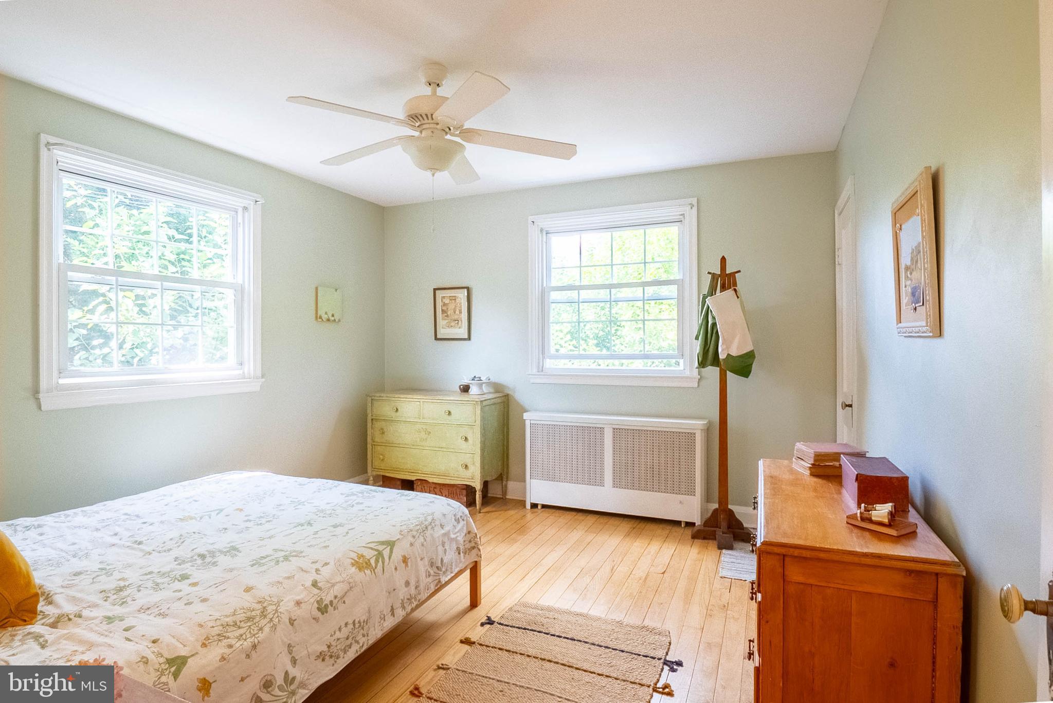 6400 Crestwood Road Baltimore, MD 21239 - Photo 25 of 39 a bedroom with a bed and wooden floor