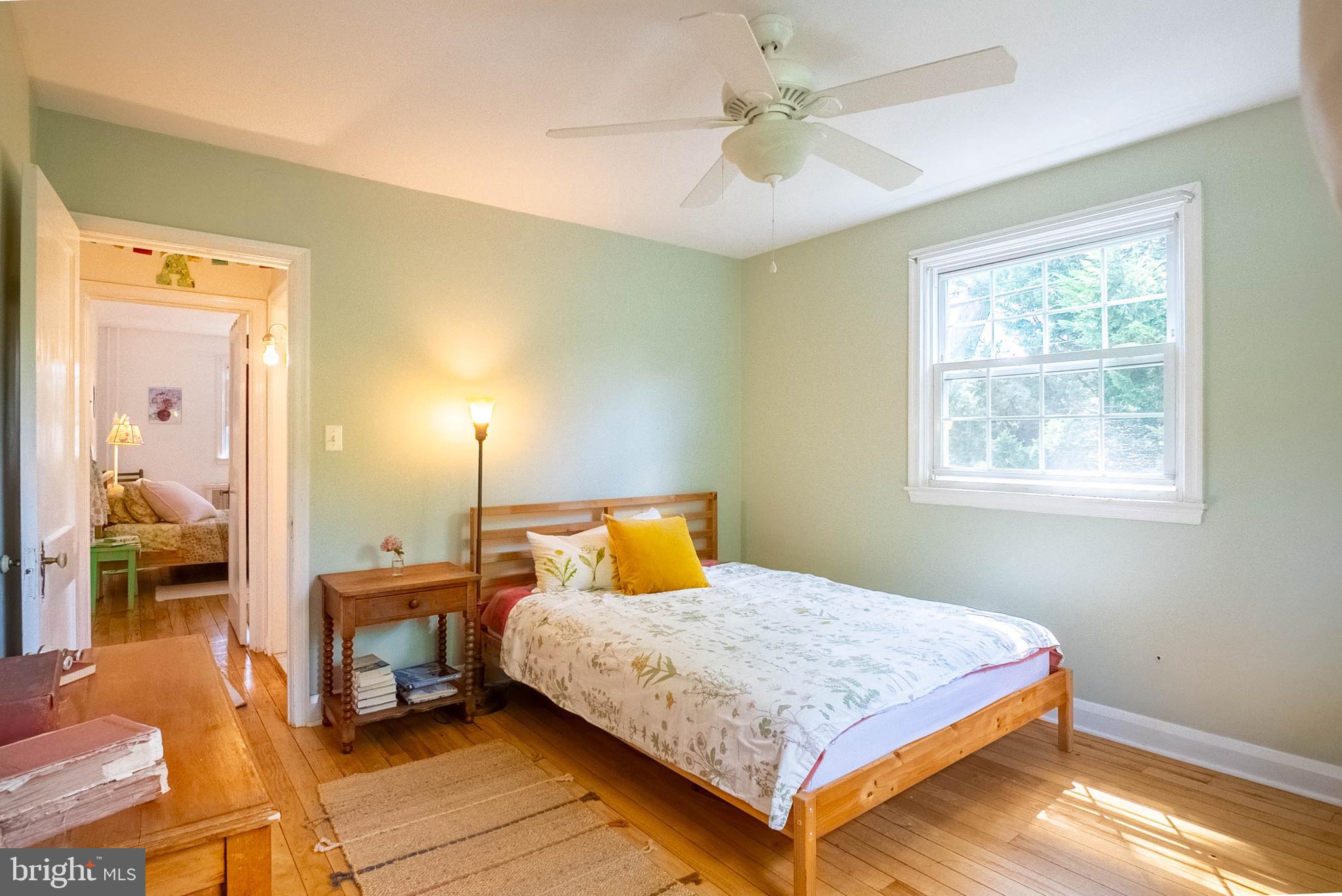 6400 Crestwood Road Baltimore, MD 21239 - Photo 26 of 39 a bedroom with a bed and wooden floor