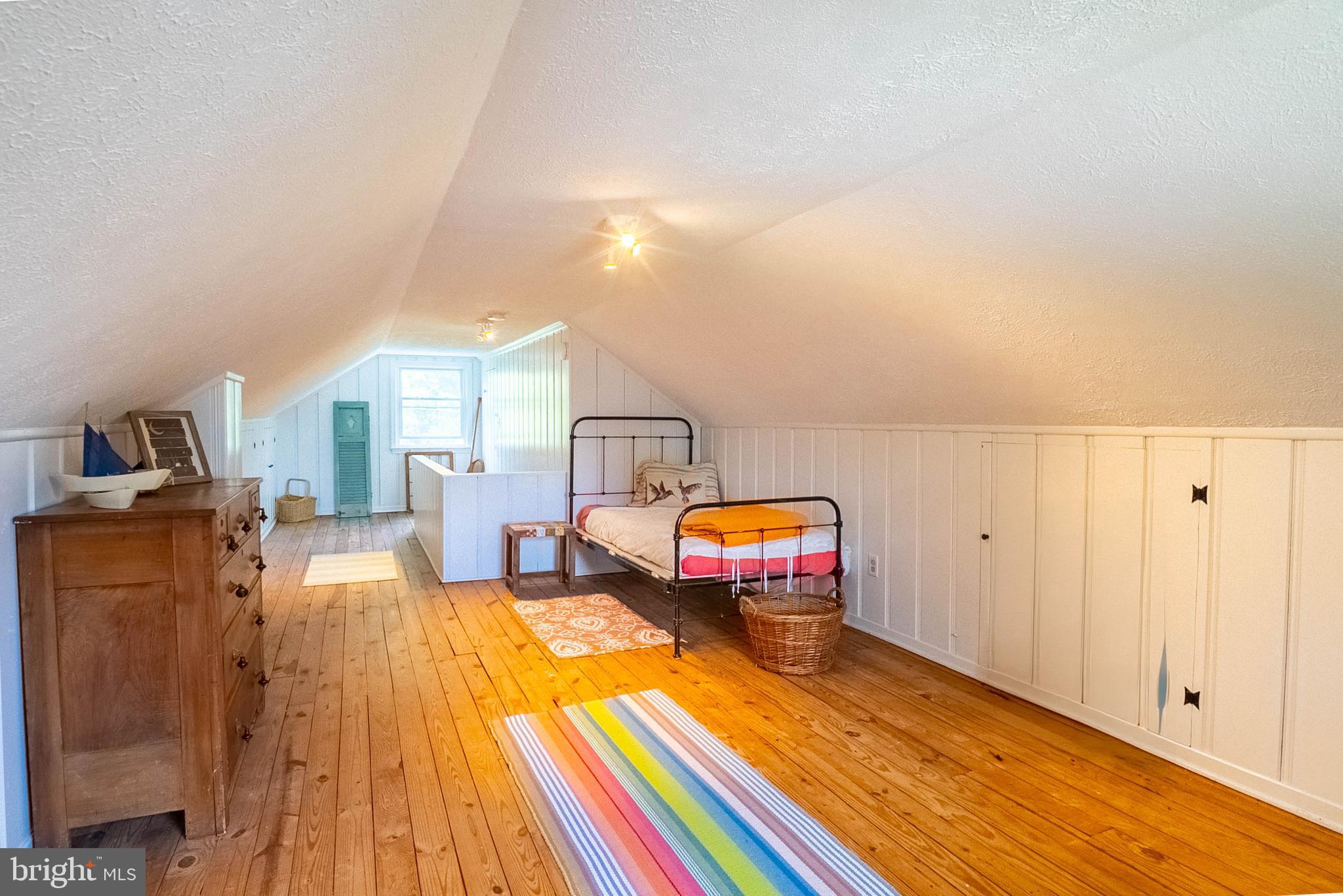 6400 Crestwood Road Baltimore, MD 21239 - Photo 28 of 39 a bedroom with furniture and a wooden floor
