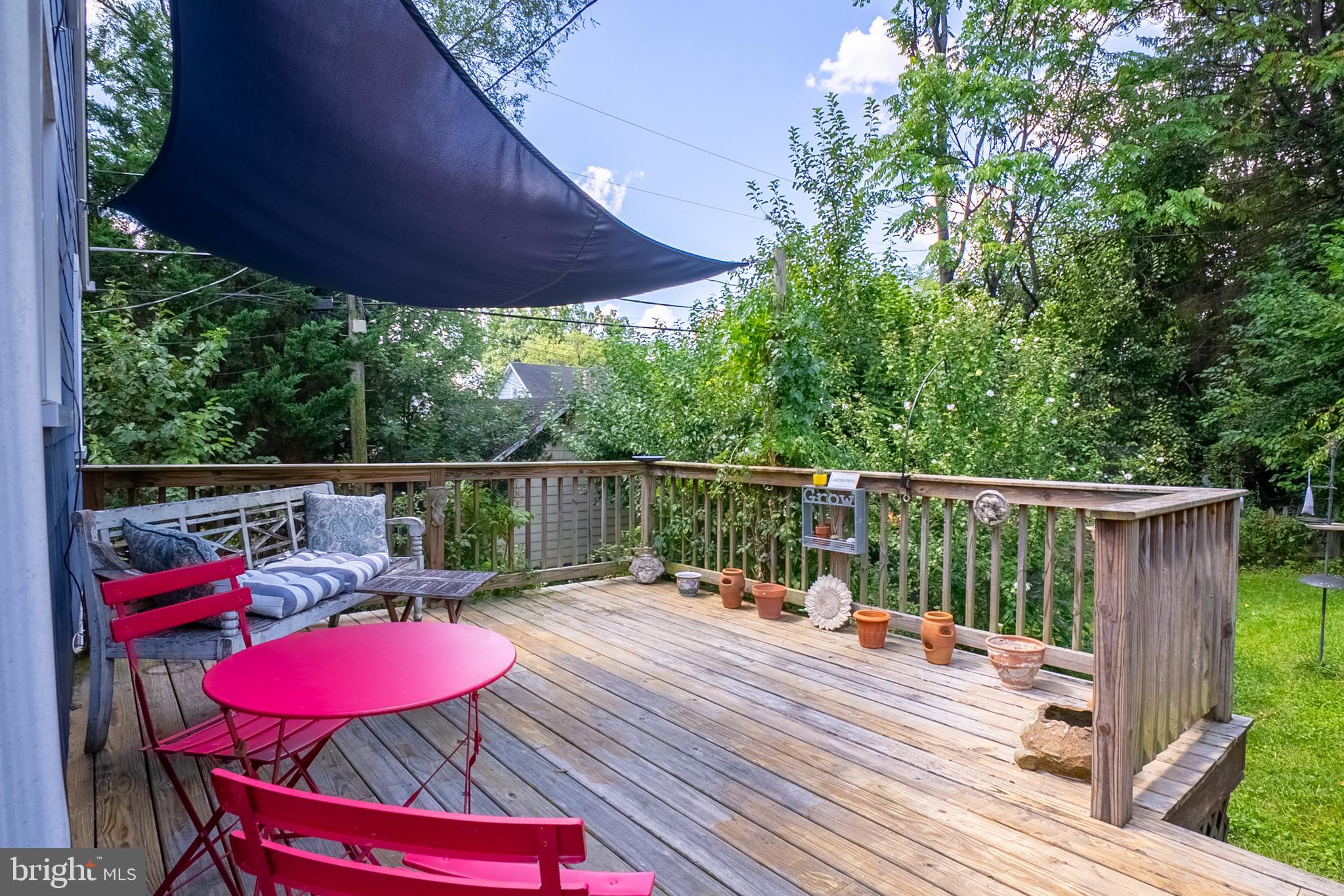 6400 Crestwood Road Baltimore, MD 21239 - Photo 32 of 39 a balcony with wooden floor table and chairs