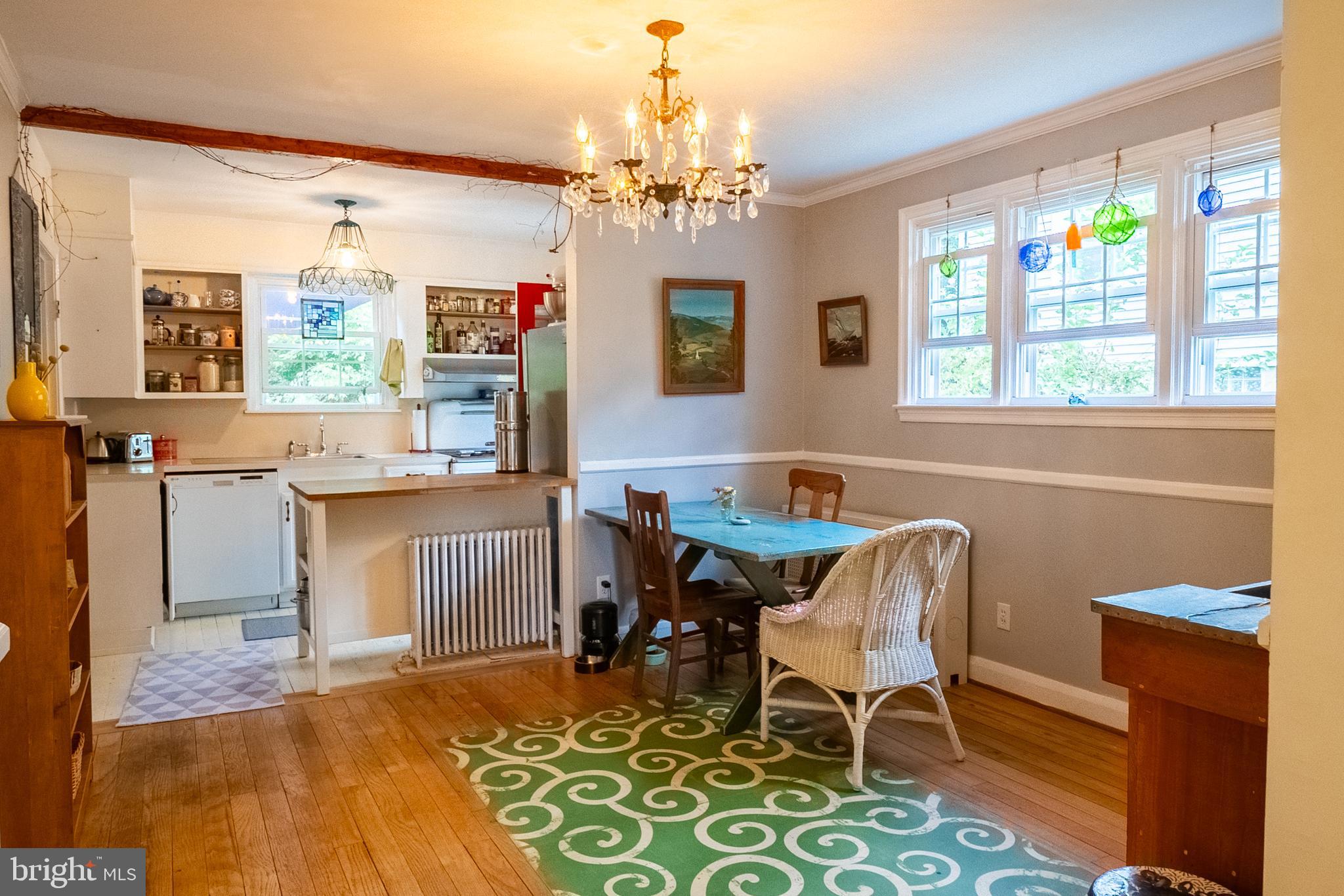 6400 Crestwood Road Baltimore, MD 21239 - Photo 10 of 39 a view of a dining room with furniture and a chandelier
