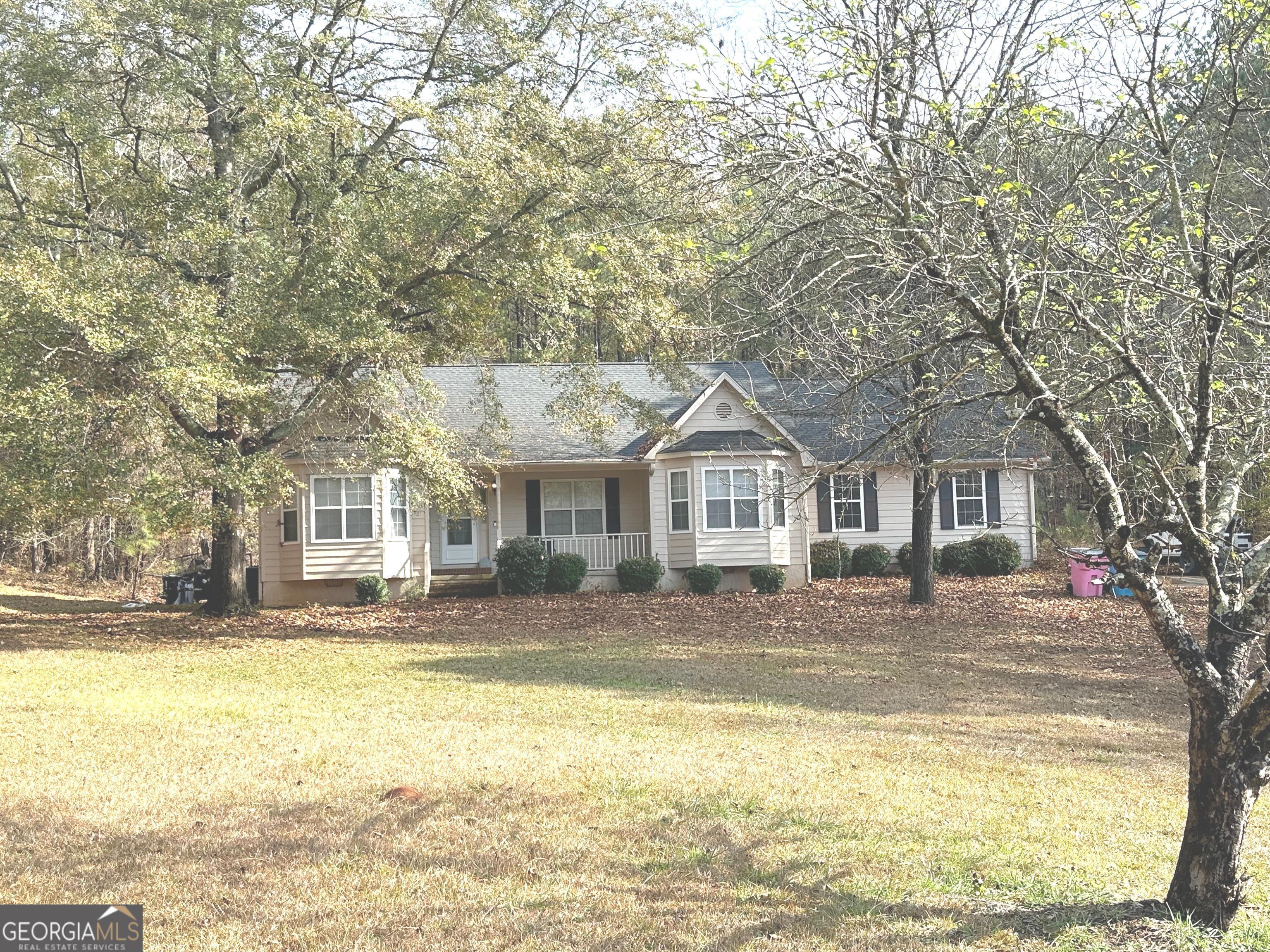 a front view of a house with swimming pool and sitting area