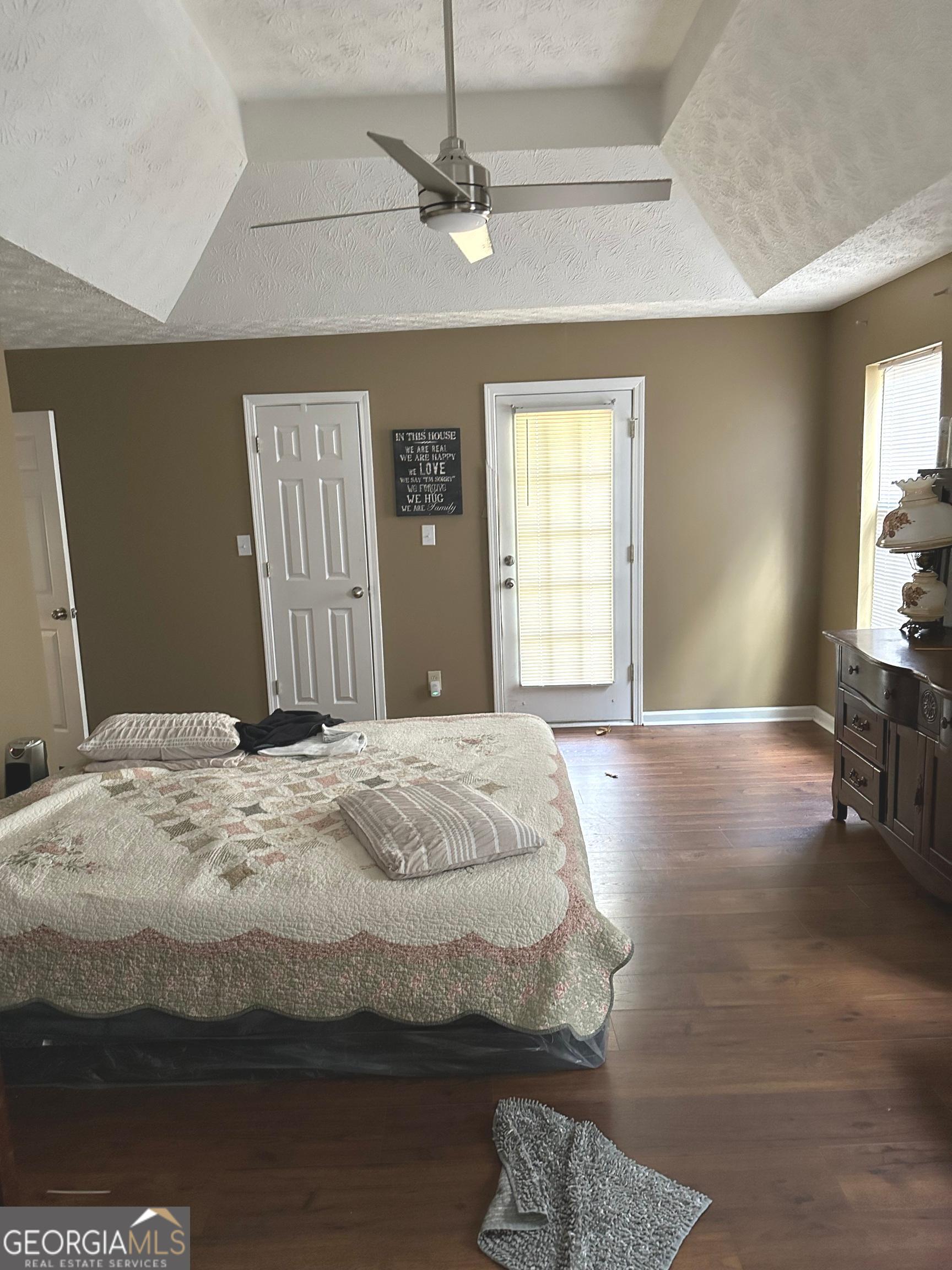 170 Ashley Trace Drive Locust Grove, GA 30248 - Photo 12 of 17 a bedroom with a bed and dresser with mirror