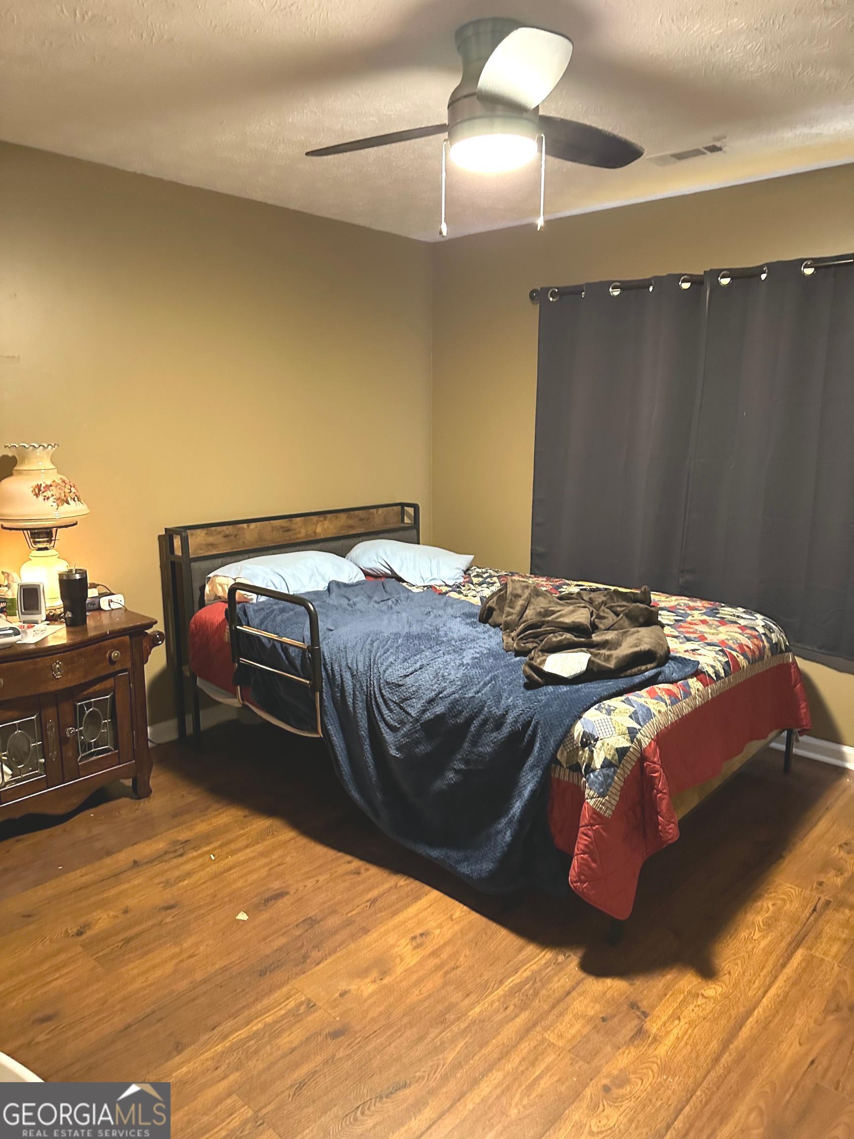 170 Ashley Trace Drive Locust Grove, GA 30248 - Photo 16 of 17 a bedroom with a bed and cabinet