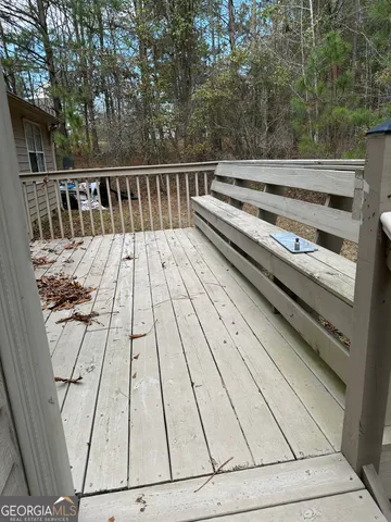 a view of backyard with deck and wooden floor