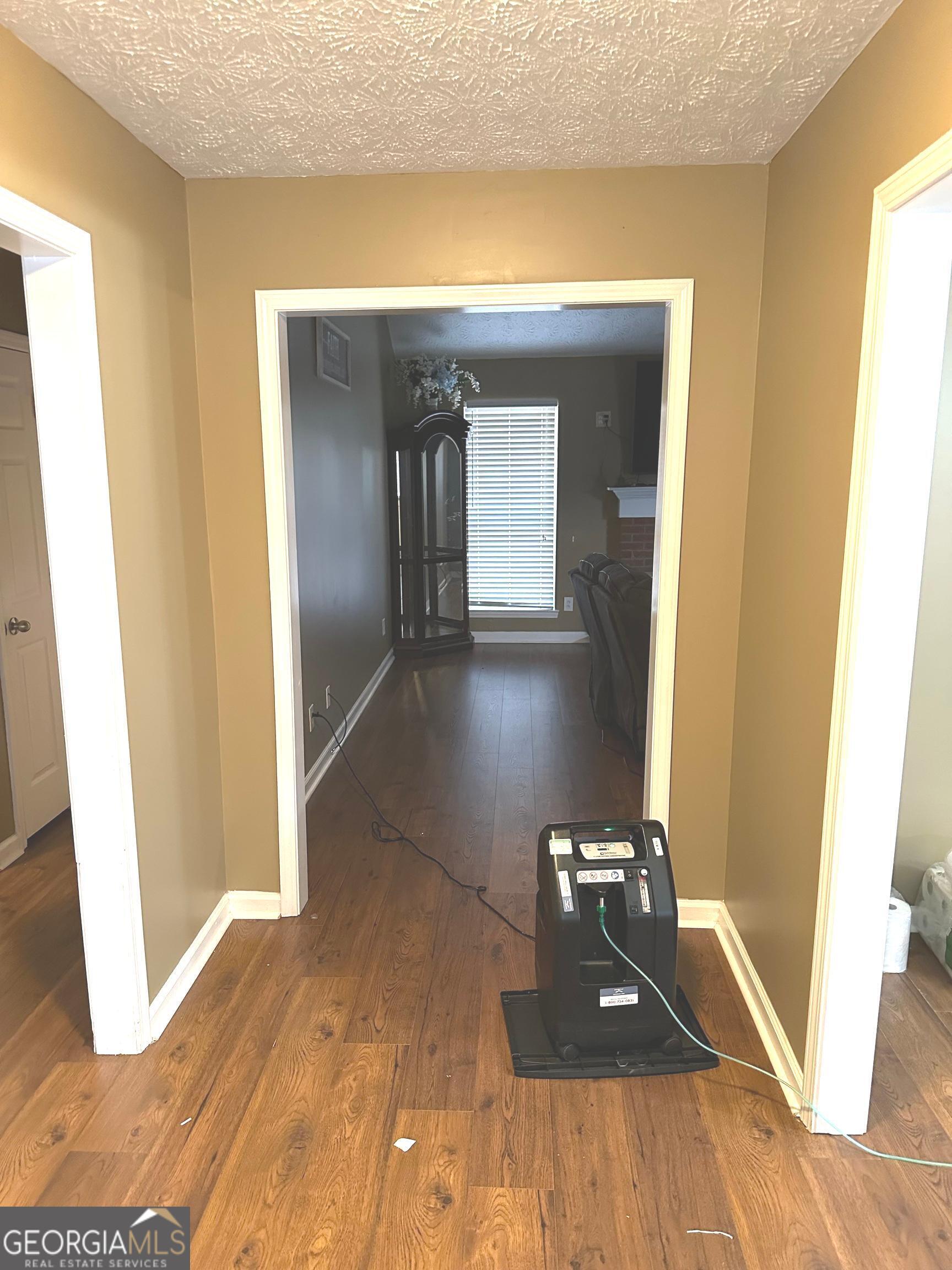 170 Ashley Trace Drive Locust Grove, GA 30248 - Photo 4 of 17 a view of a hallway with wooden floor