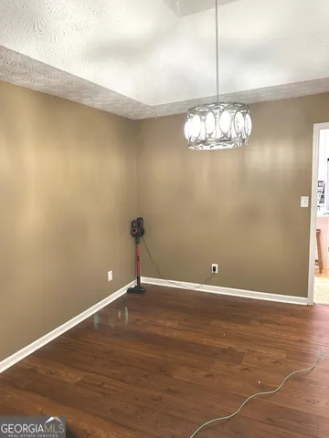 a view of wooden floor and chandelier in a room