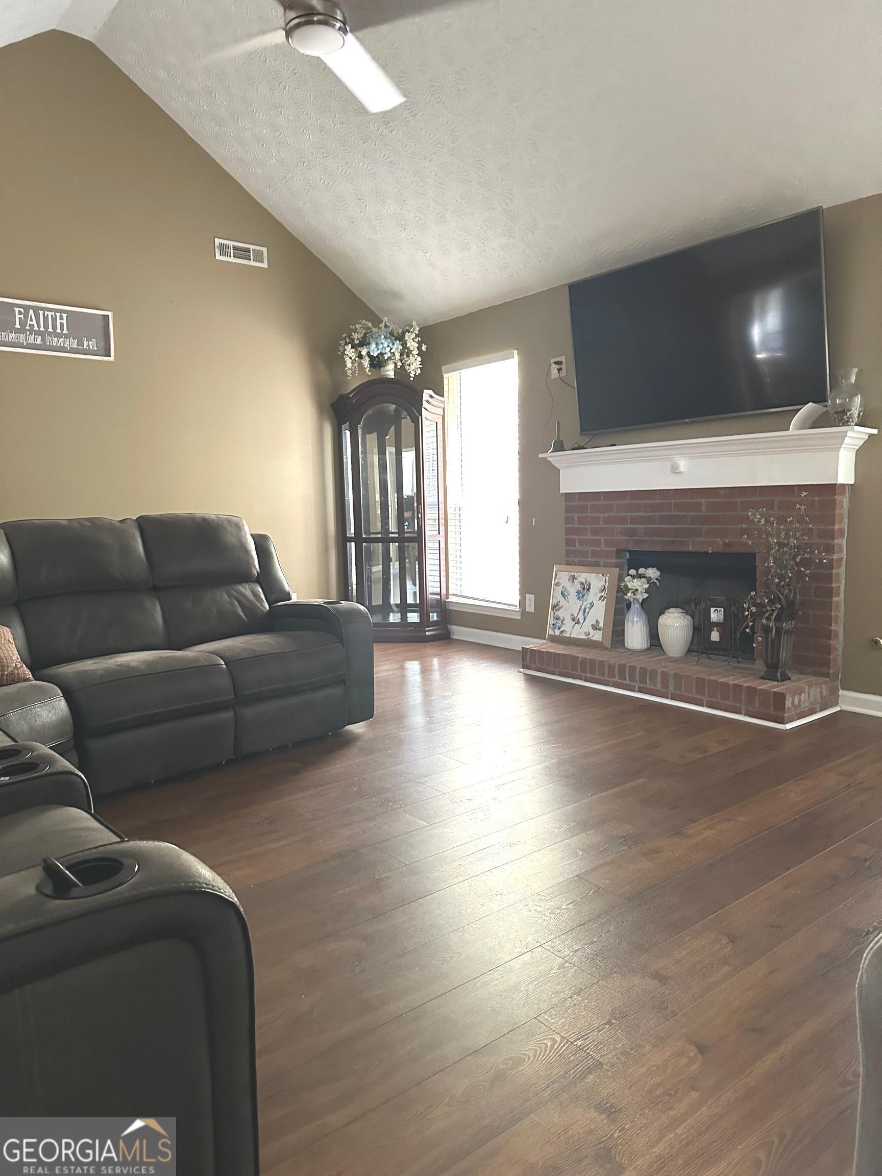 170 Ashley Trace Drive Locust Grove, GA 30248 - Photo 6 of 17 a living room with furniture and a fireplace