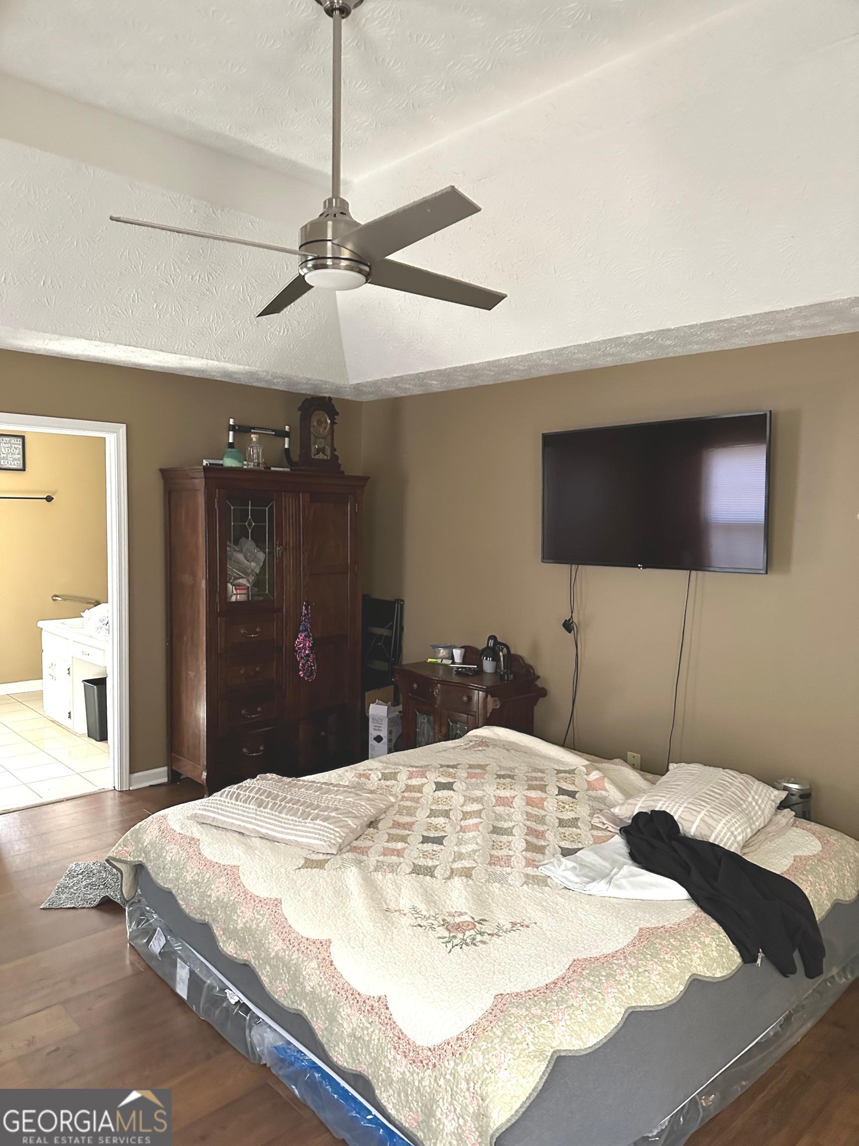 170 Ashley Trace Drive Locust Grove, GA 30248 - Photo 10 of 17 a bed in a bedroom and a flat screen tv