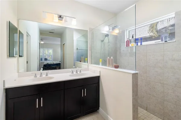 a bathroom with a double vanity sink mirror and double