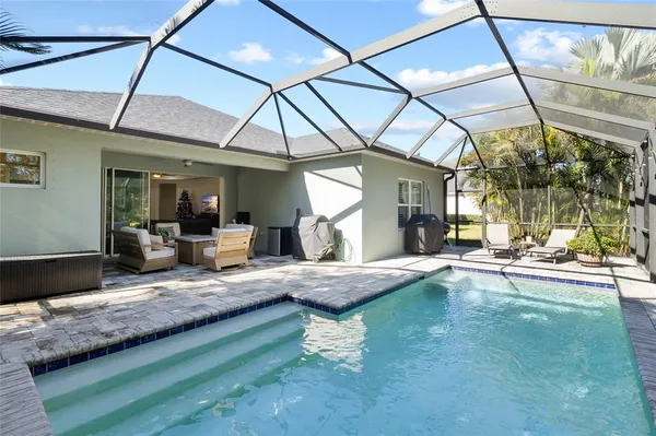 a view of swimming pool with outdoor seating