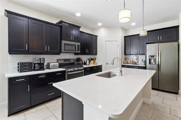 a kitchen with stainless steel appliances wooden cabinets a sink and a stove