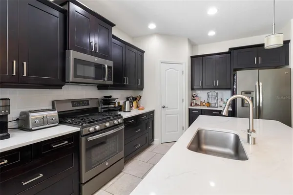a view of kitchen with microwave and cabinets