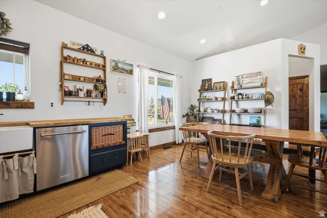 1634 West Arimo Road Arimo, ID 83214 - Photo 11 of 89 Spacious kitchen and dining area featuring wood-finish flooring, a farmhouse-style sink, stainless steel dishwasher, and natural wood shelving