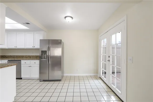 a view of a kitchen with a sink and a refrigerator