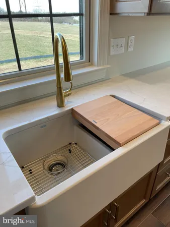 a kitchen with granite countertop a stove and a sink
