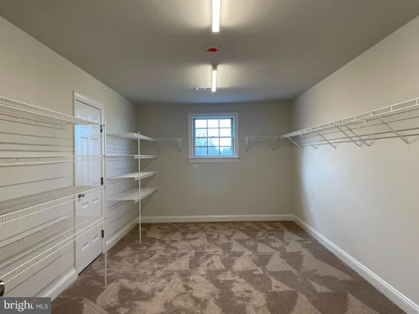 a view of an empty room and a window