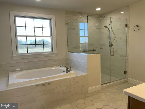 a spacious bathroom with a double vanity sink a toilet and a mirror
