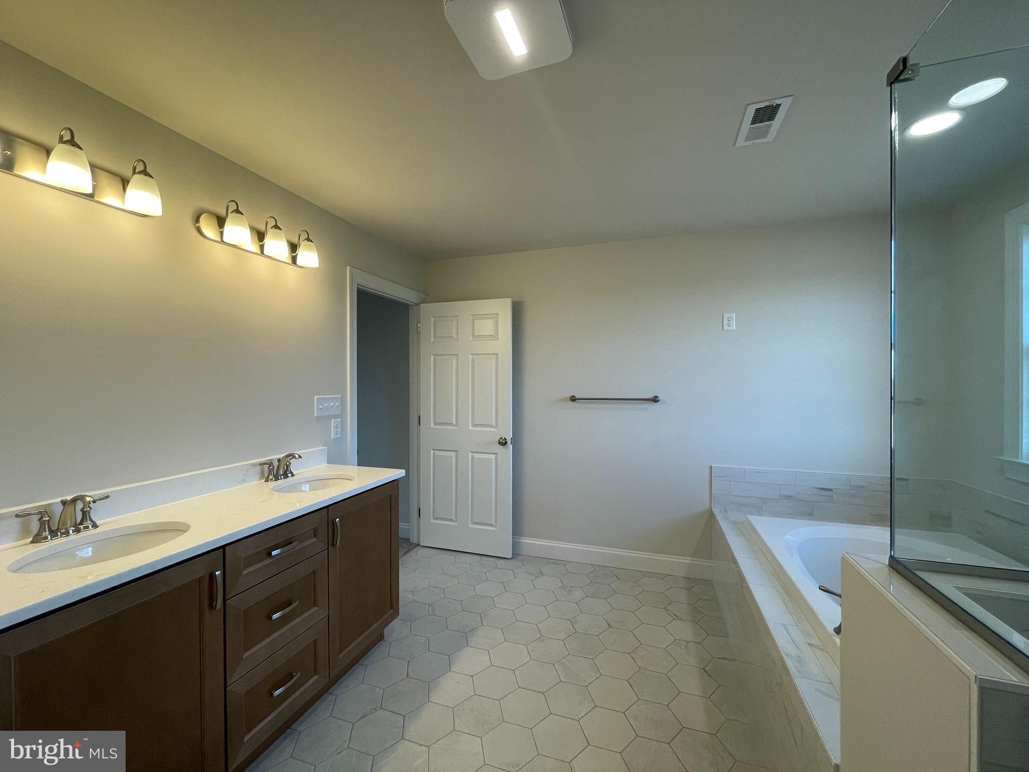 1928 Kimberton Road Phoenixville, PA 19460 - Photo 29 of 32 a spacious bathroom with a double vanity sink a toilet and a mirror