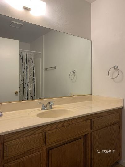 345 South Fountain Street Ridgecrest, CA 93555 - Photo 19 of 24 a bathroom with a sink and a mirror