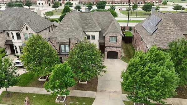 an aerial view of a house with a yard basket ball court and outdoor seating