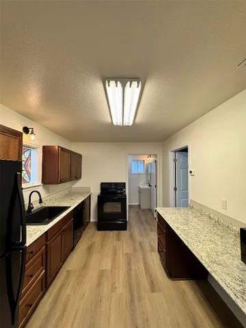 a kitchen with stainless steel appliances granite countertop a sink and stove top oven