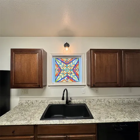 a kitchen with a sink and cabinets
