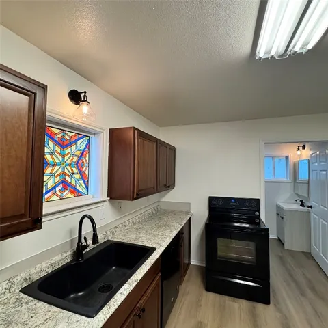 a kitchen with a sink stove and microwave