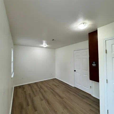 an empty room with wooden floor