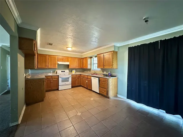 a large kitchen with cabinets and stainless steel appliances