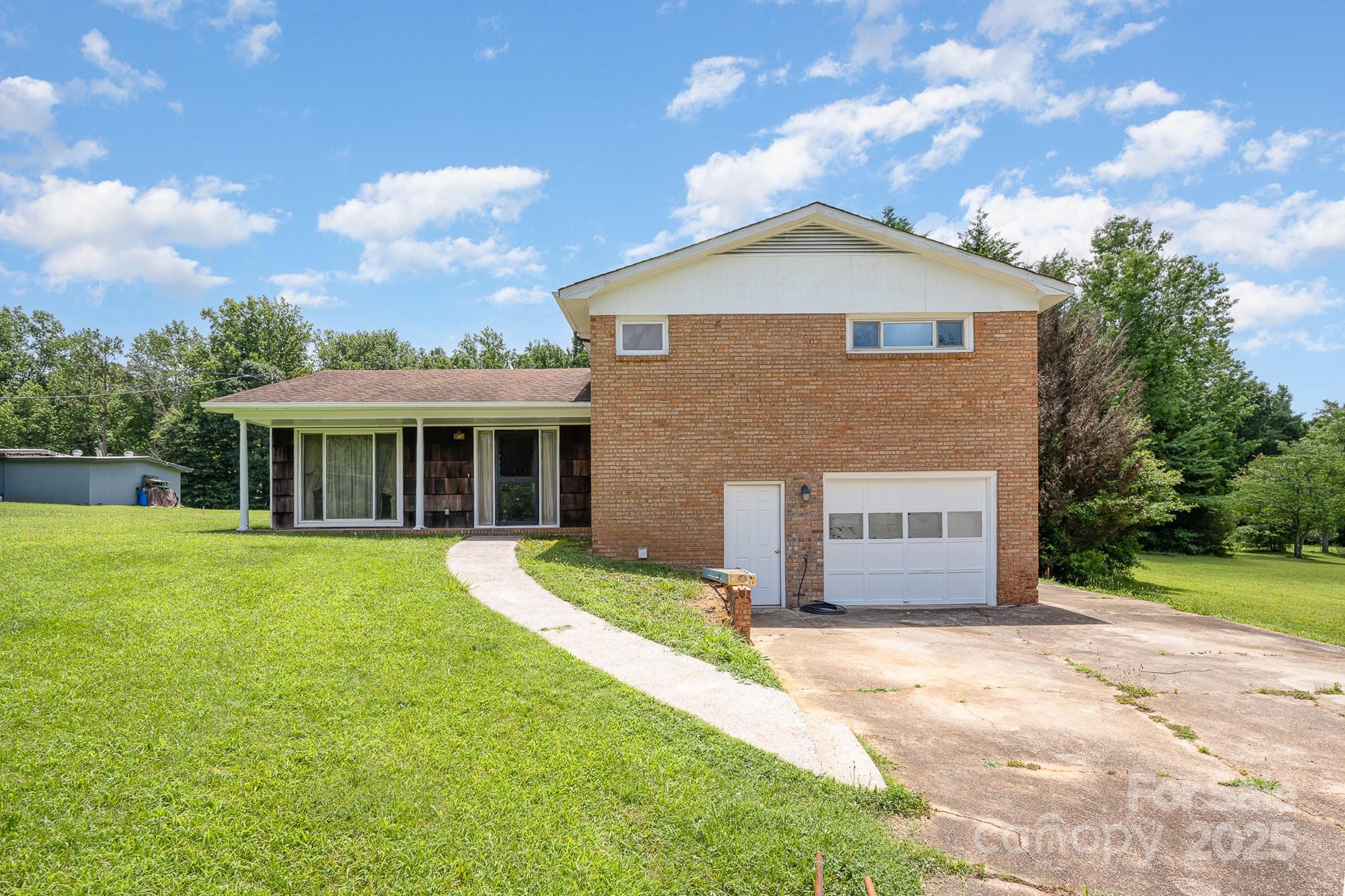 5858 Mundy Road Denver, NC 28037 - Photo 3 of 27 a front view of a house with a yard and garage