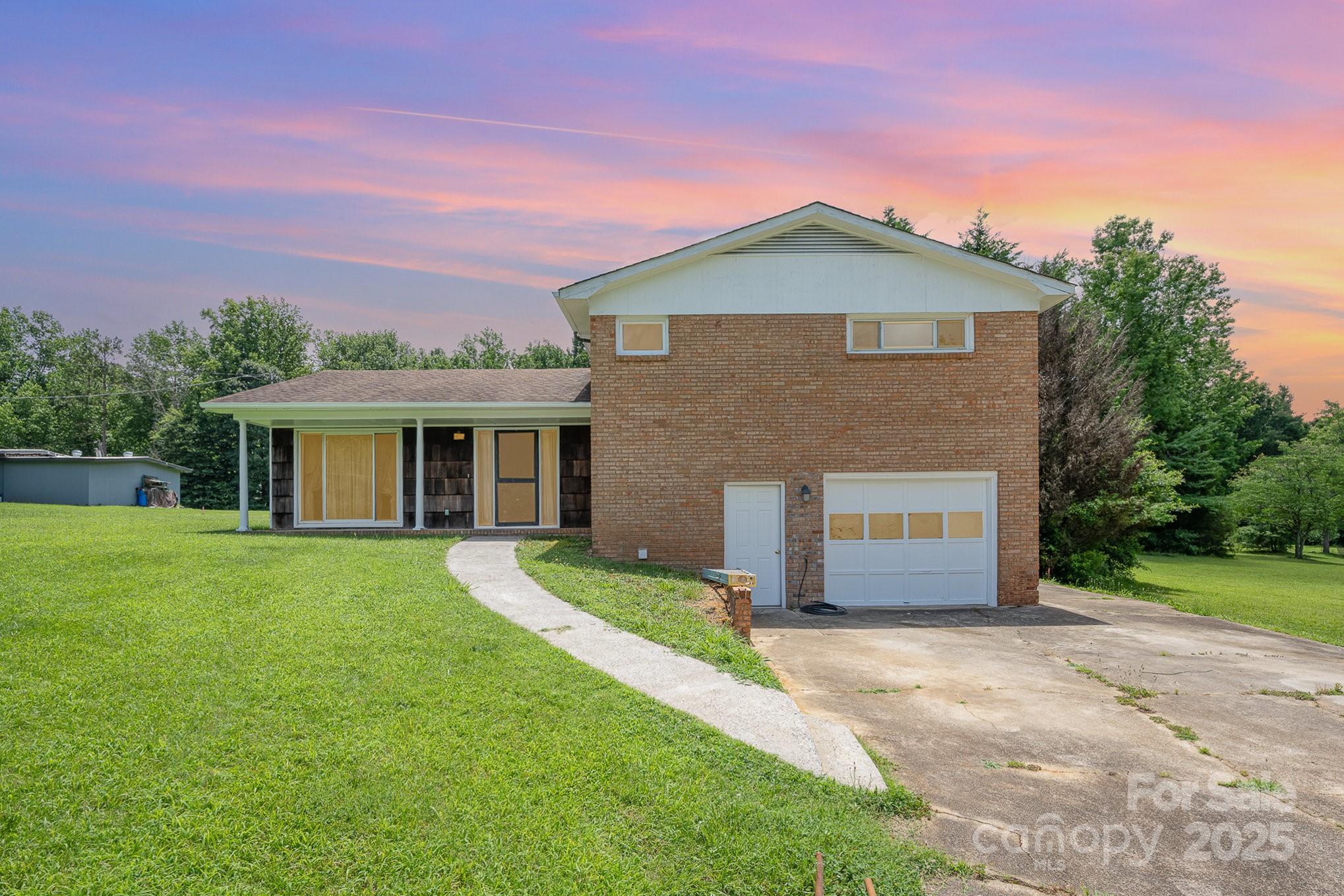 5858 Mundy Road Denver, NC 28037 - Photo 5 of 27 a front view of a house with a yard and garage