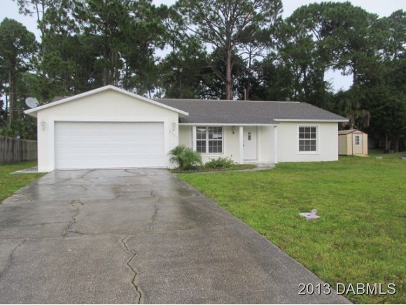 2907 Juniper Drive Edgewater, FL 32141 - Photo 1 of 12 a view of a house with a yard and large tree