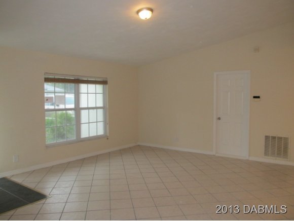 2907 Juniper Drive Edgewater, FL 32141 - Photo 6 of 12 an empty room with windows and entrance