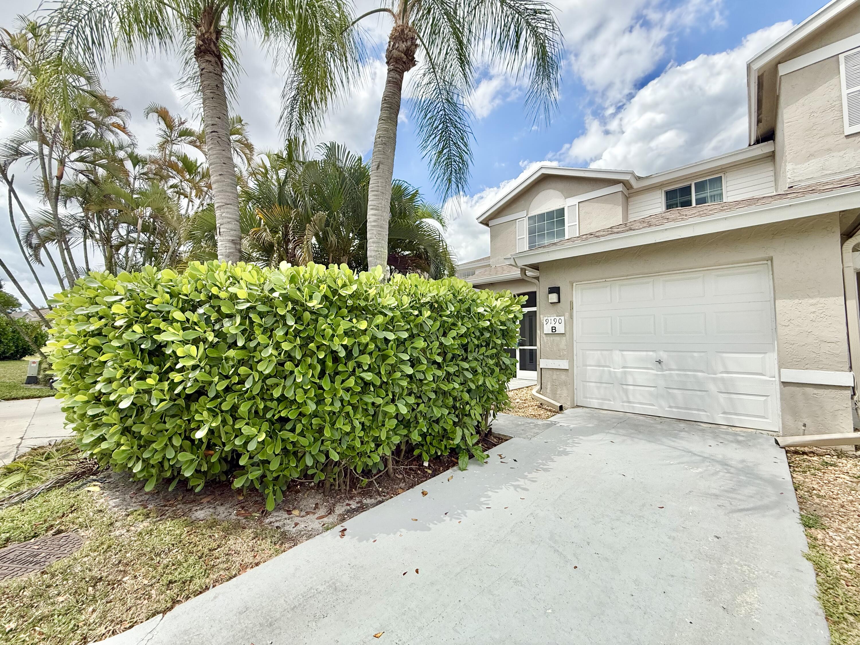 9190 Boca Gardens Parkway, Unit B Boca Raton, FL 33496 - Photo 1 of 35 a view of a house with a yard and plant