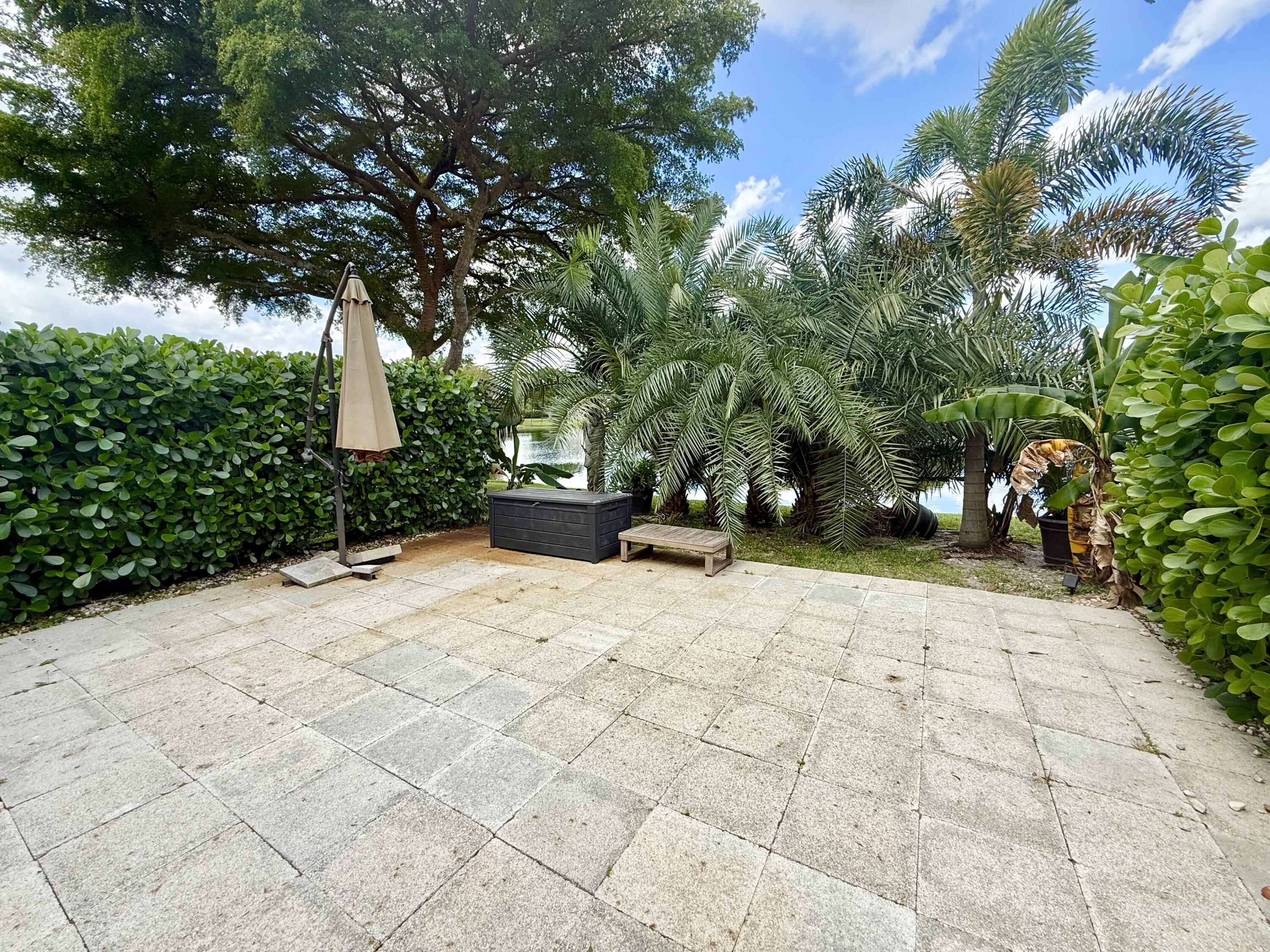 9190 Boca Gardens Parkway, Unit B Boca Raton, FL 33496 - Photo 11 of 35 a view of a backyard with plants and trees