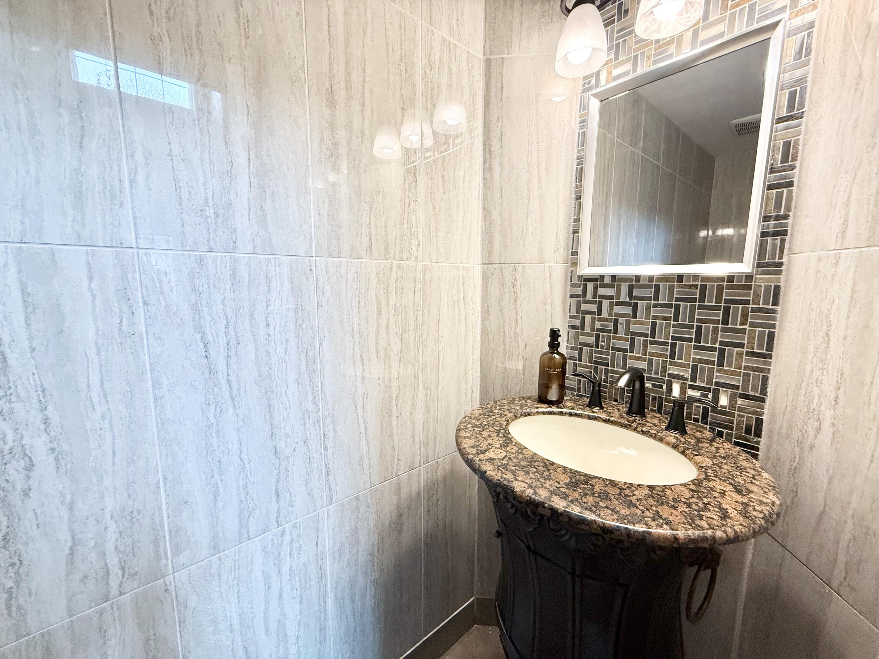 9190 Boca Gardens Parkway, Unit B Boca Raton, FL 33496 - Photo 18 of 35 a bathroom with a granite countertop sink and a mirror