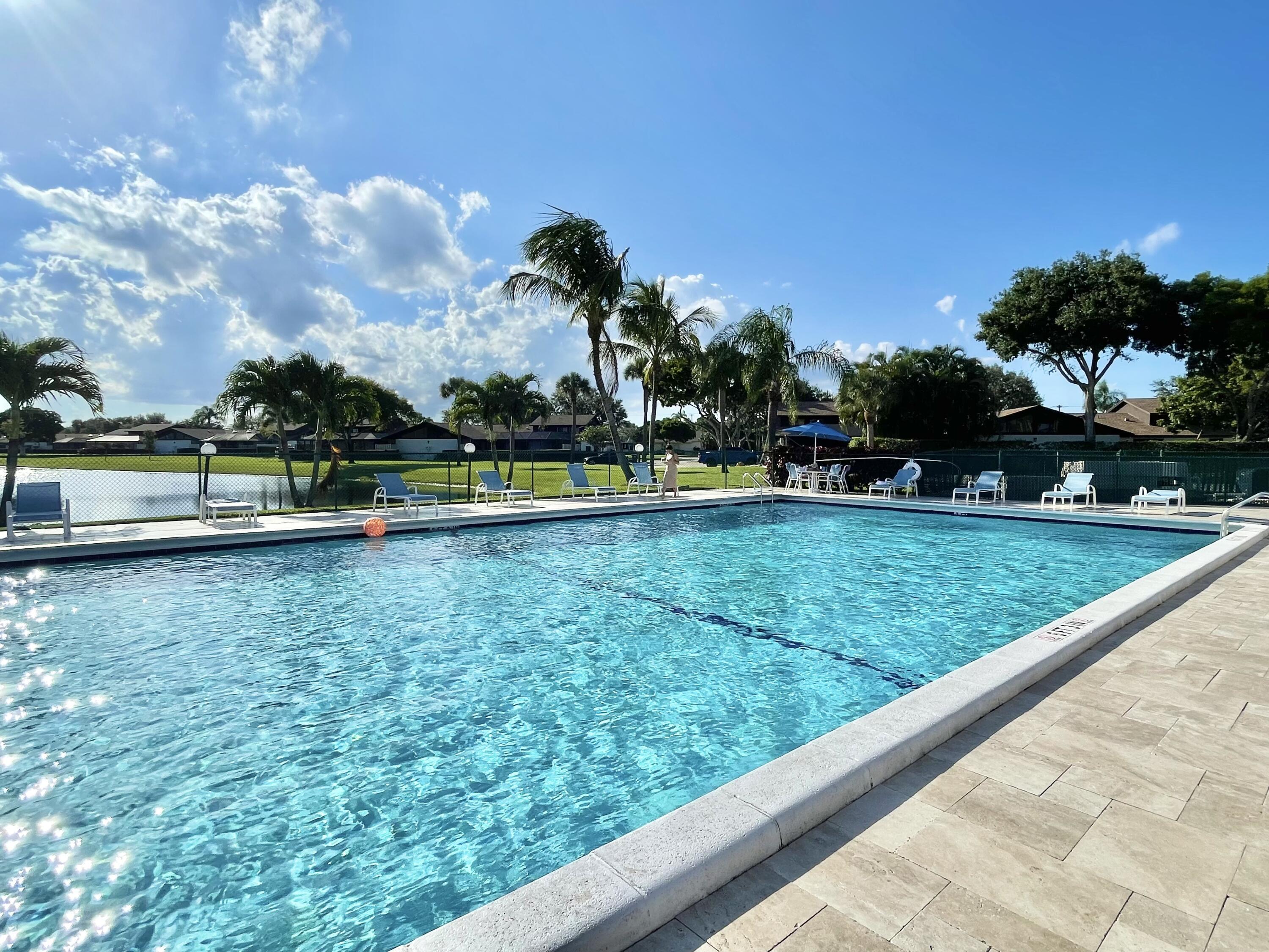 9190 Boca Gardens Parkway, Unit B Boca Raton, FL 33496 - Photo 29 of 35 a view of swimming pool with a yard