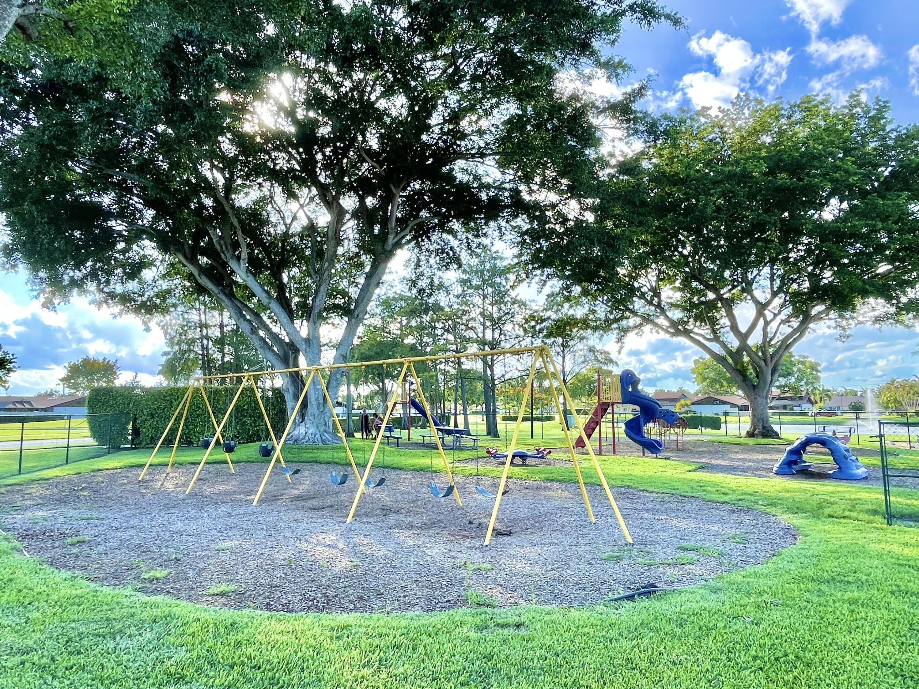 9190 Boca Gardens Parkway, Unit B Boca Raton, FL 33496 - Photo 35 of 35 a view of outdoor space with playground and green space