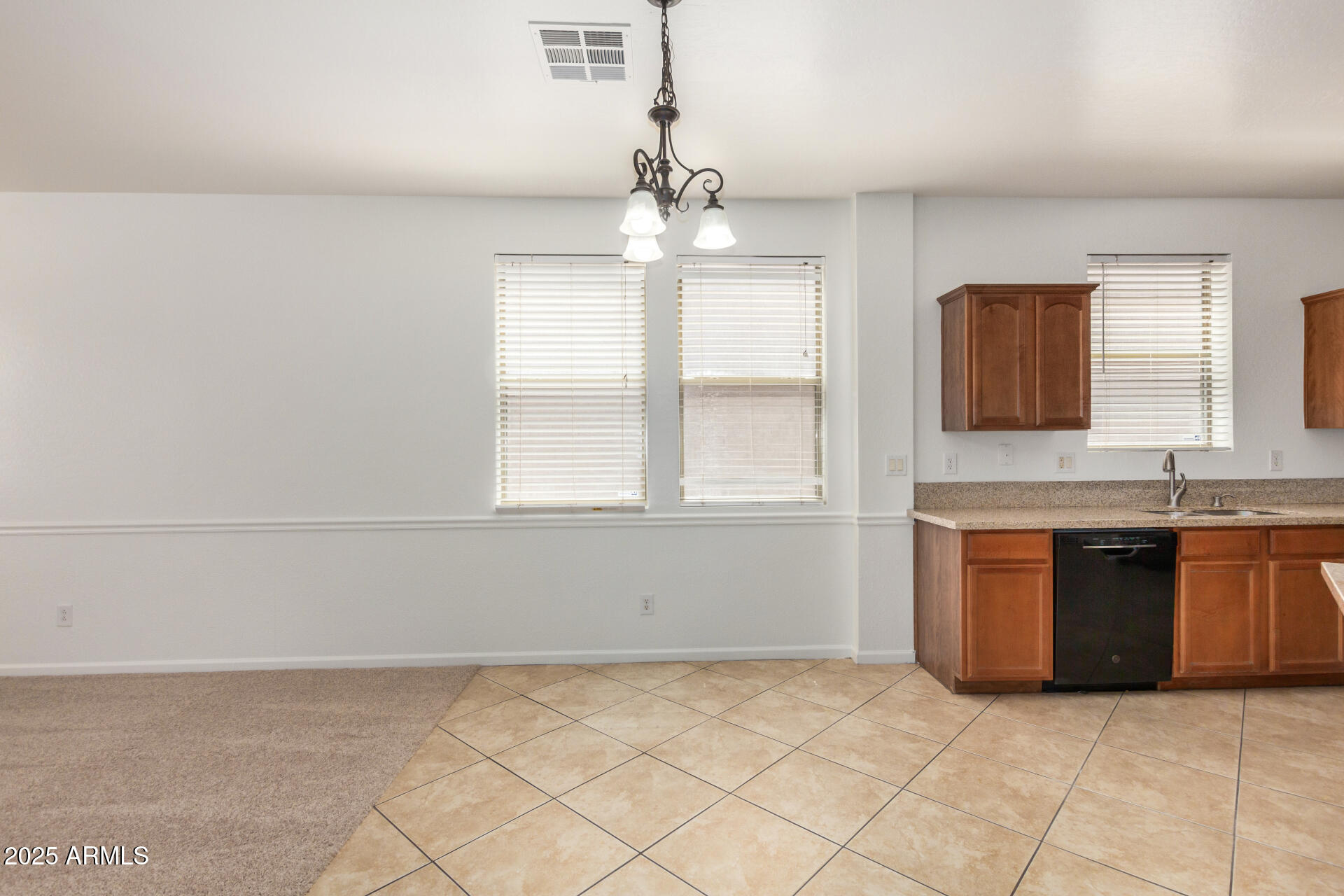 18475 North Madison Road Maricopa, AZ 85139 - Photo 11 of 40 a kitchen with granite countertop a sink cabinets and window