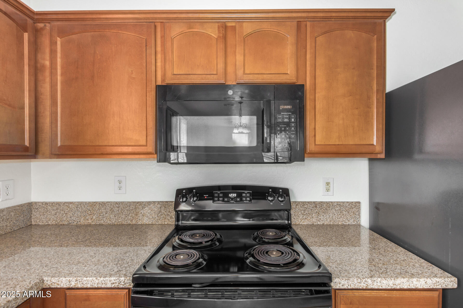 18475 North Madison Road Maricopa, AZ 85139 - Photo 15 of 40 a kitchen with granite countertop a stove and a sink