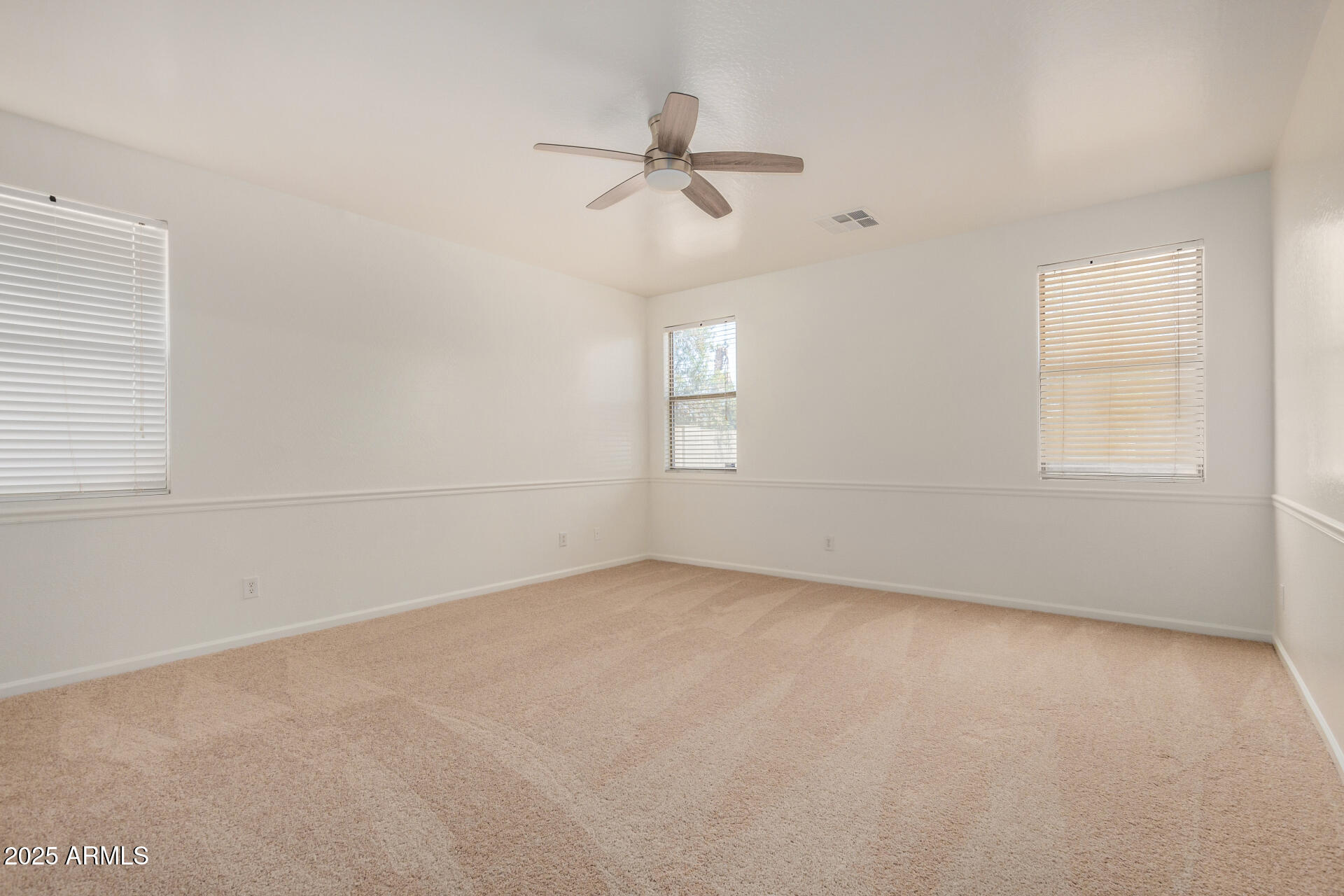 18475 North Madison Road Maricopa, AZ 85139 - Photo 17 of 40 an empty room with a window and a ceiling fan