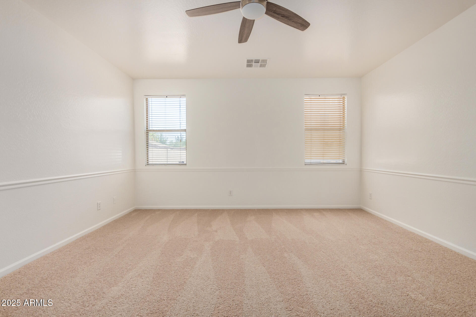 18475 North Madison Road Maricopa, AZ 85139 - Photo 18 of 40 an empty room with windows