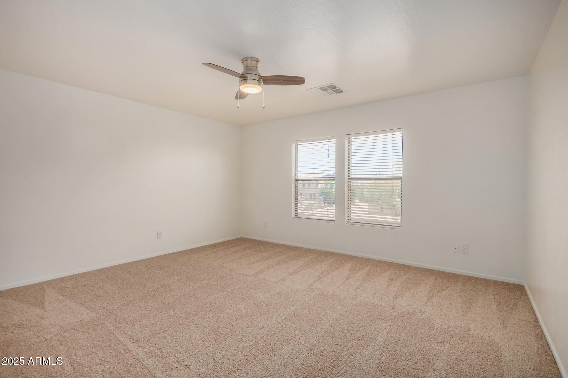 18475 North Madison Road Maricopa, AZ 85139 - Photo 22 of 40 an empty room with a window and ceiling fan