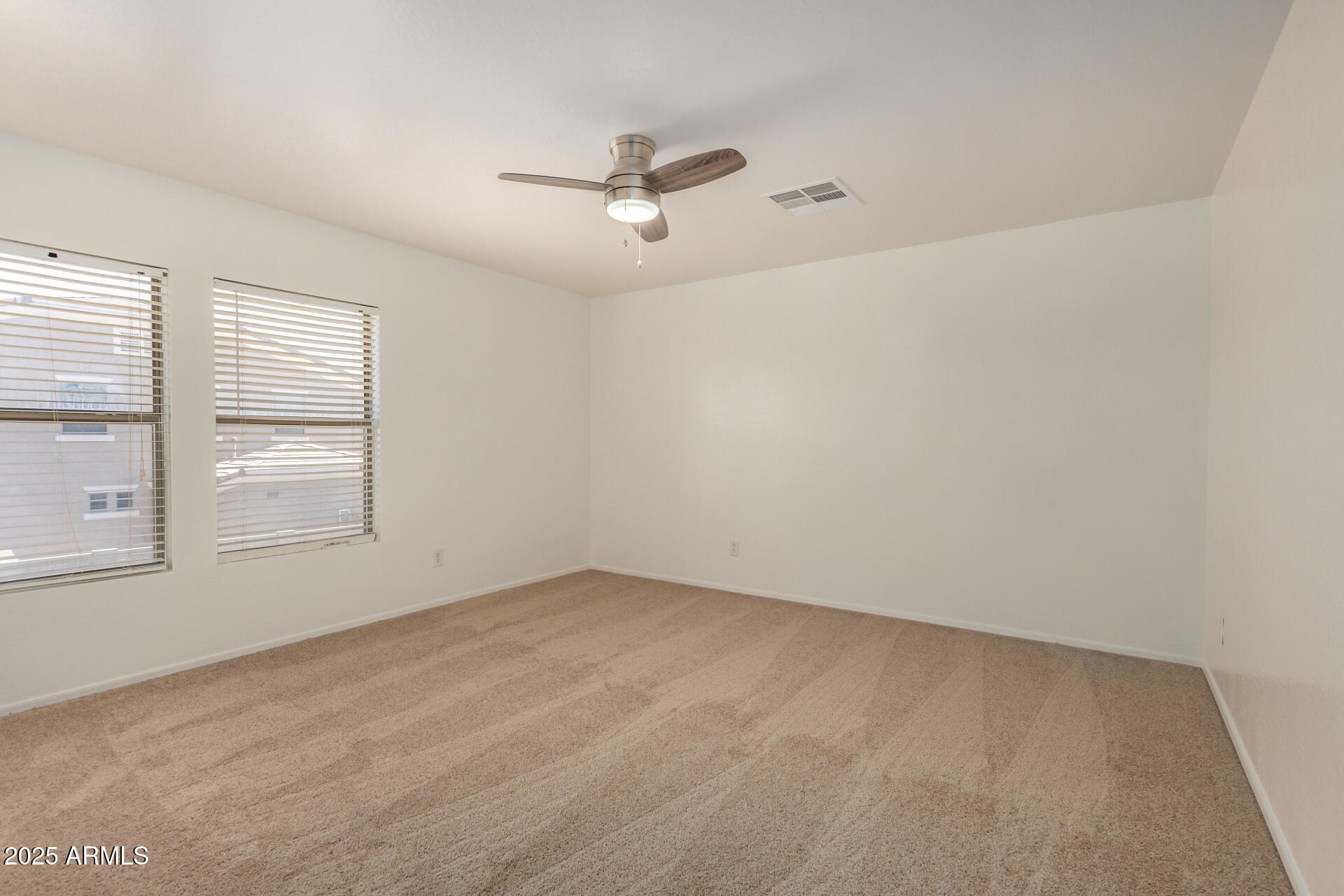 18475 North Madison Road Maricopa, AZ 85139 - Photo 24 of 40 an empty room with windows and ceiling fan view